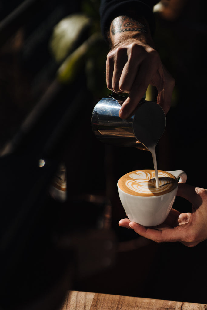 Sean pouring perfect latte art lifestyle photo by clive coffee