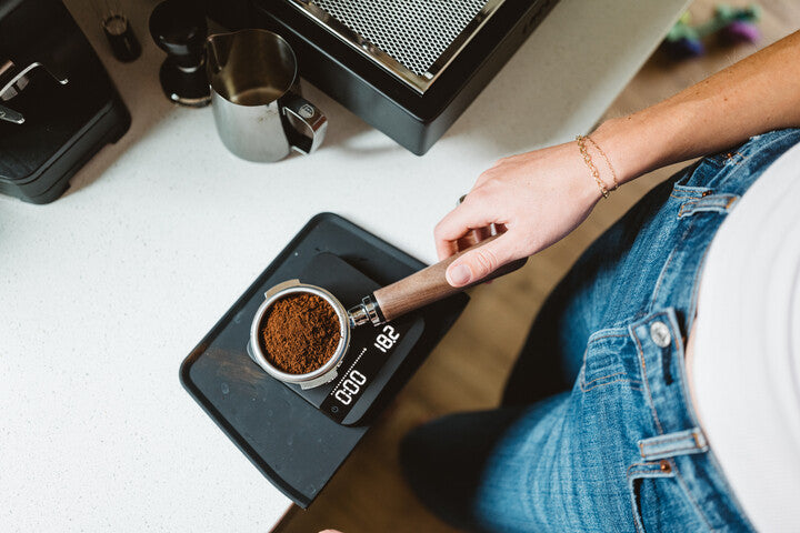 weighing coffee on a lunar espresso scale lifestyle by ben matthews