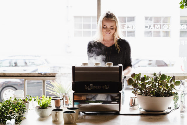 Woman steaming milk on a La Spaziale single group espresso machine, Clive Coffee - Lifestyle