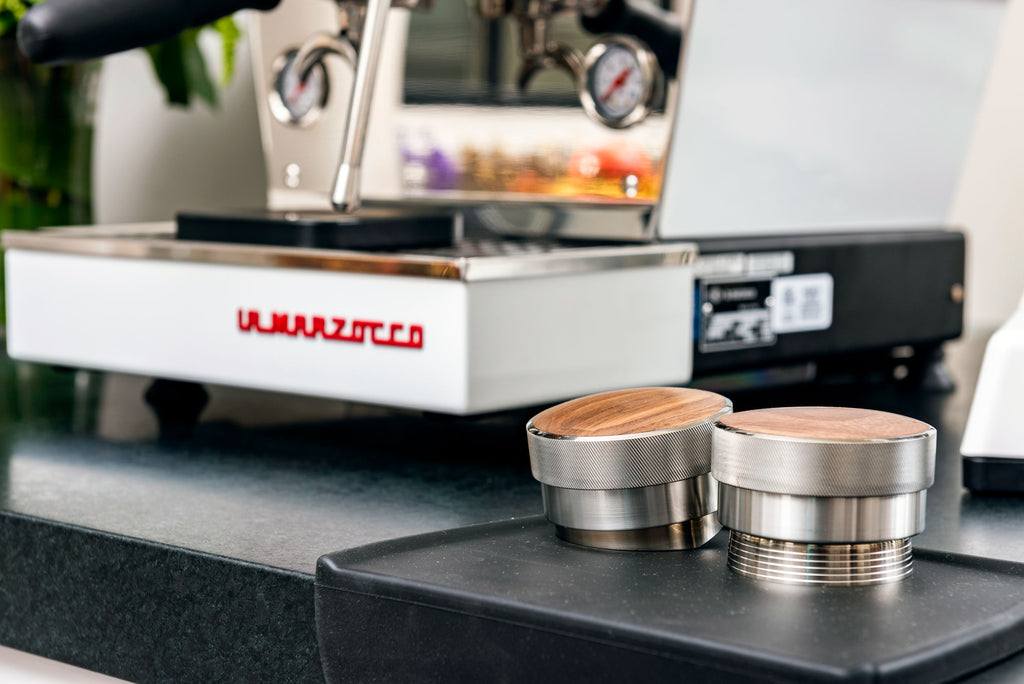 Saint Anthony Distribution Wedge and Tamper next to the La Marzocco Linea Mini espresso machine