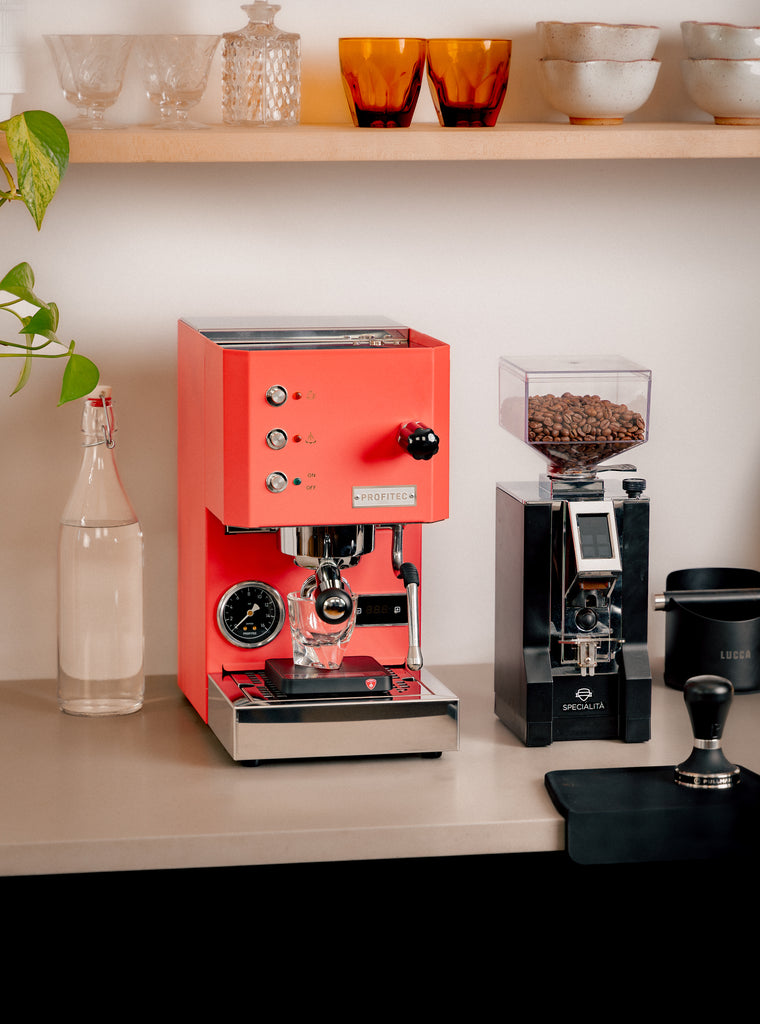 Profitec Go in red and Specialita grinder in black lifestyle photo by clive coffee