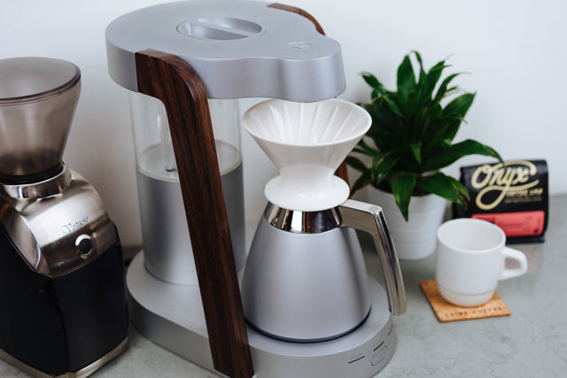 The Ratio Thermal Carafe in Bright Silver alongside a Baratza Virtuoso - Lifestyle