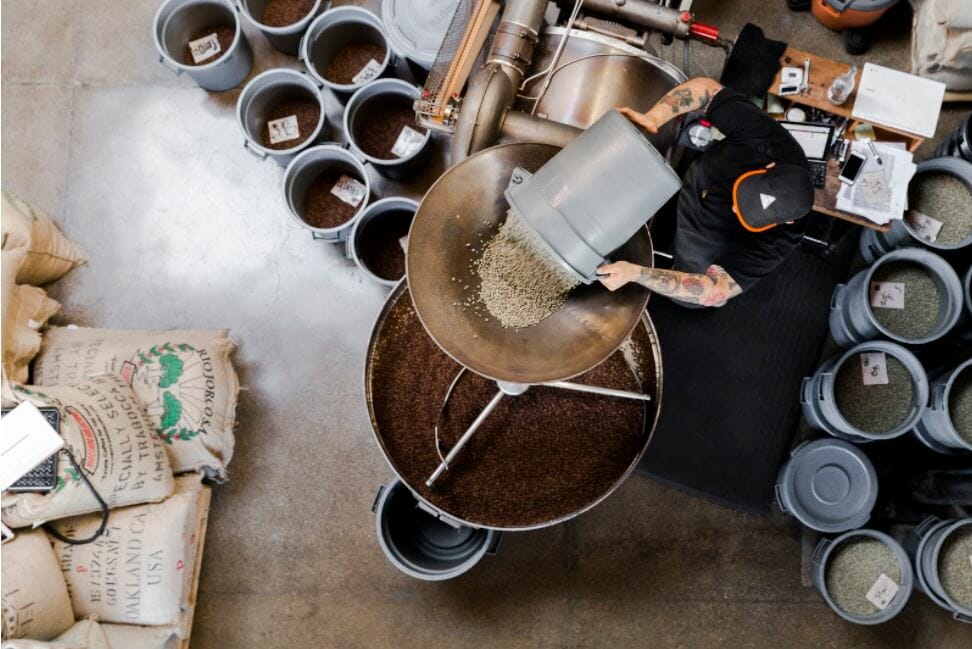 Loading the raw green beans into the hopper at Sightglass Coffee, photo by Michael O’Neal